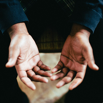 person showing both palms while sitting on chair